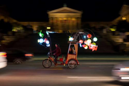 Pedicab with lanterns at night