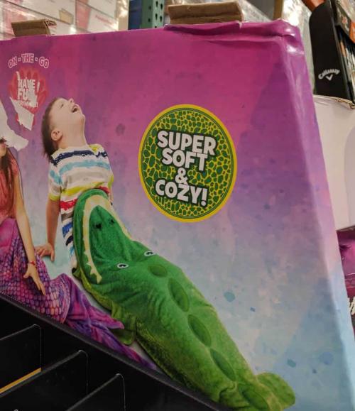 A photo of packaging, a kids toy, but the packaging makes the kid look like they are being eaten. Or wose.
